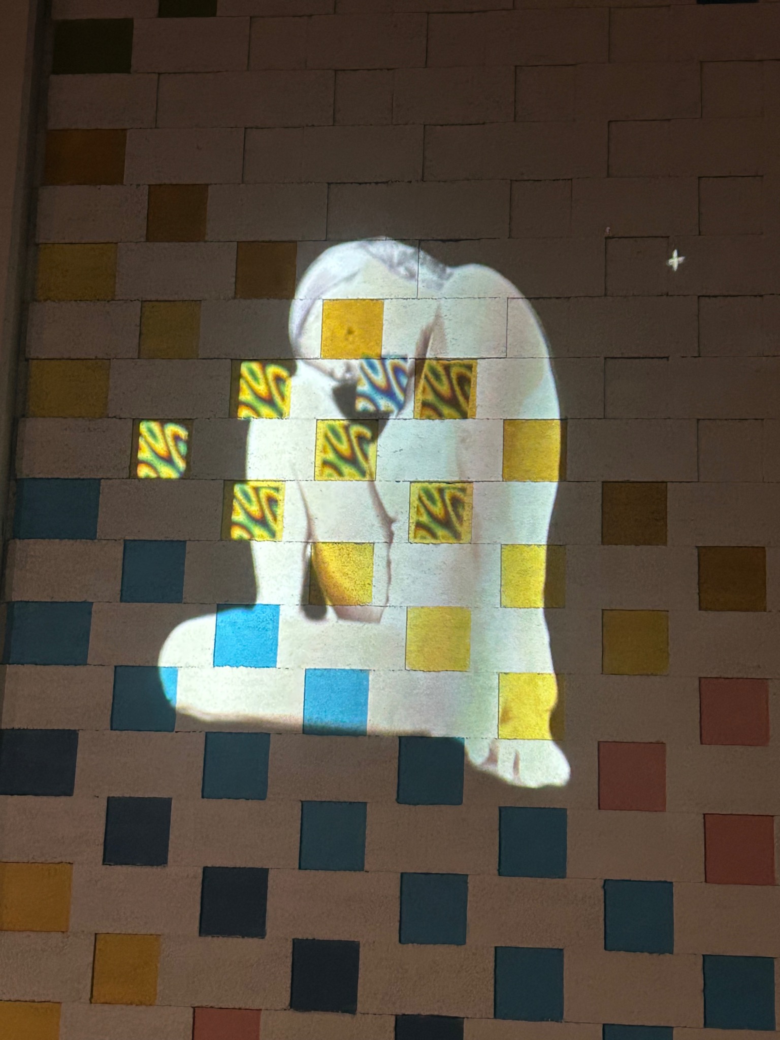 Projection mapped portrait across a geometric wall surface